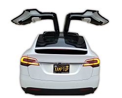 logo for pop up cbt photo of tesla model x with falcon doors fully extended